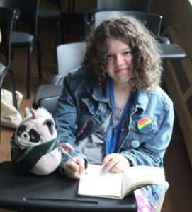 girls student writing in notebook