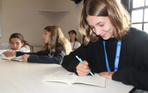 girl student looking down writing